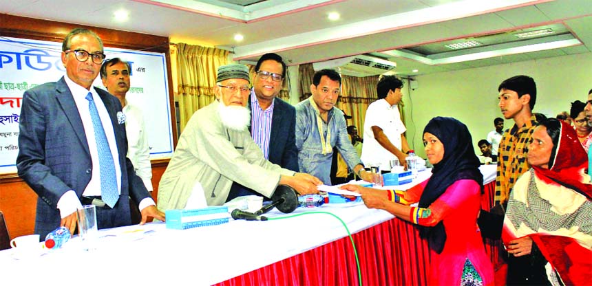 Engineer A.K.M Mosharraf Hossain, Chairman, Jamuna Bank, handing over scholarships to students at "Scholarship giving ceremony" organized by Jamuna Bank Foundation for under-privileged and autistics but meritorious students and the children of its emplo