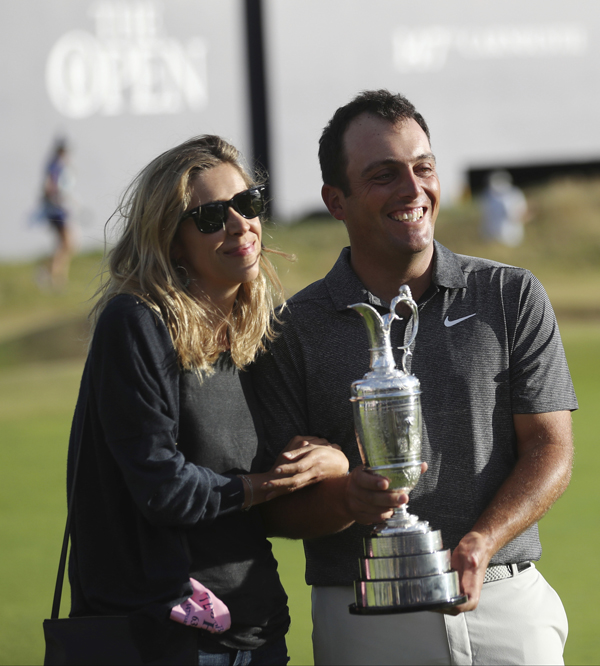 Francesco Molinari of Italy holds the trophy and his wife Valentina Molinari after winning the British Open Golf Championship in Carnoustie, Scotland on Sunday.