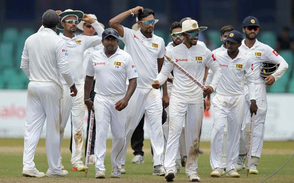 Sri Lankan players leave the ground as they celebrate their win over South Africa on the fourth day of their second Test cricket match in Colombo, Sri Lanka on Monday. Sri Lanka won the series 2-0.