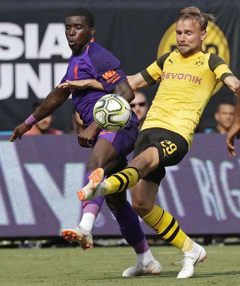 Liverpool's Sheyi Ojo (left) battles Borussia Dortmund's Marcel Schmelzer (29) during the second half of an International Champions Cup tournament soccer match in Charlotte, N.C. on Sunday.