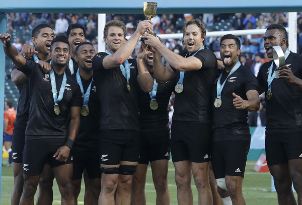 New Zealand players celebrate after beating England in the Rugby Sevens World Cup championship final in San Francisco. New Zealand won 33-12 on Sunday.