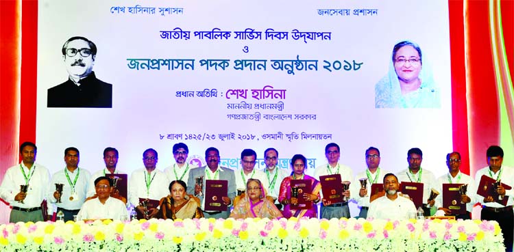 Prime Minister Sheikh Hasina at a photo session with the recipients of Public Administration Award 2018 at the city's Osmani Memorial Auditorium on Monday.