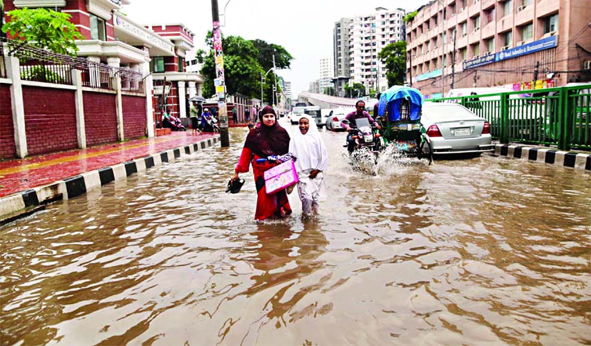 Due to incessant and heavy rain, city's many streets inundated by water. This picture was taken from the north gate of Rajarbagh Police Line on Monday.