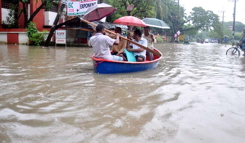 People are seen using boat for communication at Chattogram as roads are inundated due to continuous downpour. This picture was taken from CDA Residential Area in Agrabad yesterday.