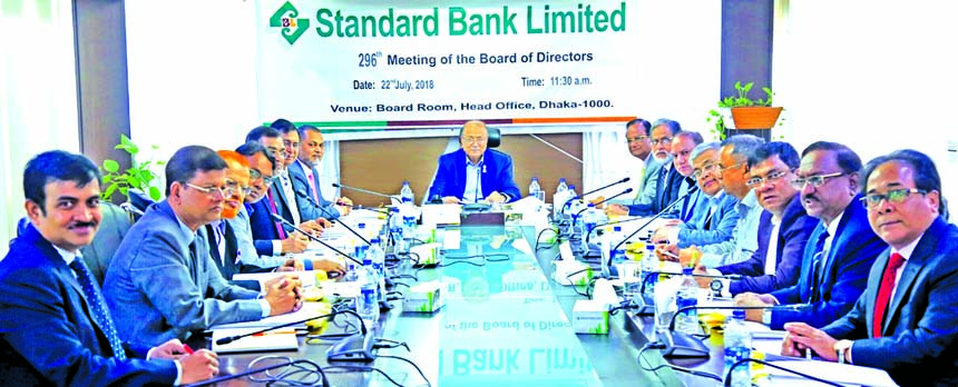 Kazi Akram Uddin Ahmed, Chairman of the Board of Directors of Standard Bank Limited, presiding over its 296th meeting at its head office in the city on Sunday. Mamun-Ur-Rashid, Managing Director, Mohammed Abdul Aziz, Vice-Chairman, Kamal Mostafa Chowdhury