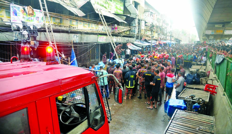 Fire fighters bring the fire under control instantly after Bangabazar Tin Shed Market in the city caught fire on Tuesday.
