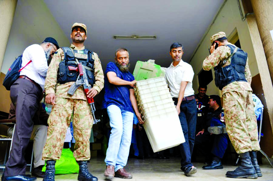 Armed soldiers watched closely as election officials in the capital Islamabad Tuesday distributed ballot boxes and voting materials for polling stations across the city.