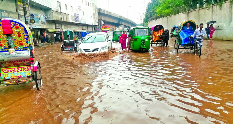 Due to absence of adequate drainage management, a busy road along the city's Bangabhaban area were inundated by rain water causing sufferings to the commuters on Tuesday.