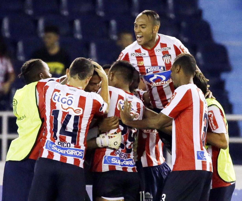 Payers of Colombiaâ€™s Junior celebrate beating Argentina's Lanus in a penalty shootout during a Copa Sudamericana second round soccer match at the Roberto Melendez stadium in Barranquilla, Colombia on Tuesday. Junior qualified for the round of sixt