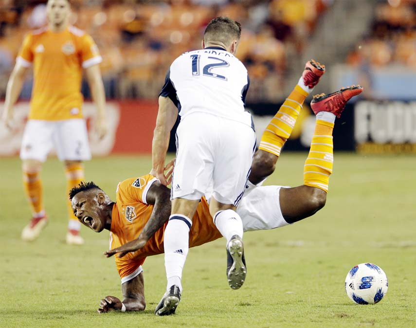 Houston Dynamo forward Romell Quioto goes down after a push by Philadelphia Union defender Keegan Rosenberry (12) during the first half of an MLS soccer match in Houston on Wednesday.