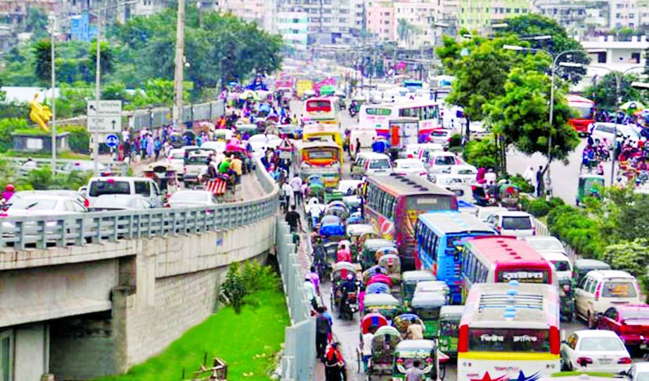 City experiences huge traffic gridlock as hundreds of vehicles got stuck for several hours due to rain and dilapidated condition of roads. This photo was taken from Rampura area on Thursday.
