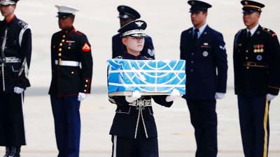 The remains were carried in boxes covered in blue United Nations flags.