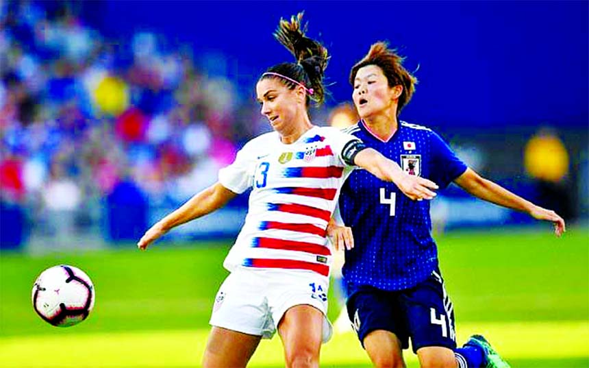 Alex Morgan of USA (L) fights for the ball with Japan's Shiori Miyake in their Tournament of Nations game at Children's Mercy Park in Kansas City on Thursday.
