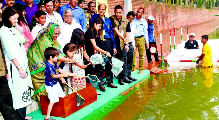 Prime Minister Sheikh Hasina releasing fish fries at Ganabhaban Lake on Monday in observance of the National Fishery Week-2018. BSS photo