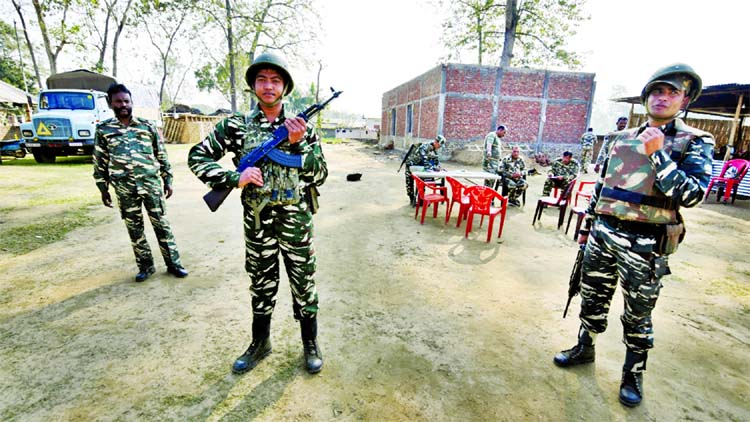 Central Reserve Police Force (CRPF) personnel stand guard at a temporary camp ahead of the publication of the first draft of the National Register of Citizens (NRC).