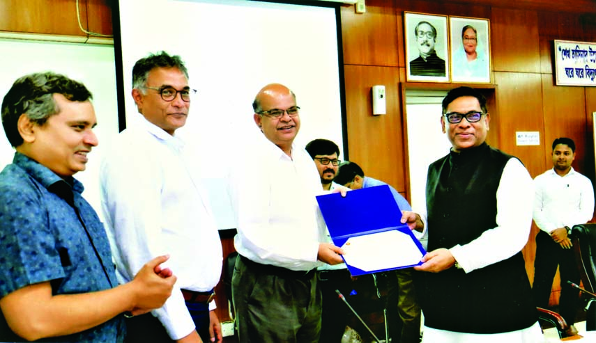 State Minister for Power, Energy and Mineral Resources Nasrul Hamid handing over Memorandum of Recognition to the Chairman of Power Development Board Engineer Khaled Mahmud for his outstanding role in power sector at a ceremony held at Bijoy Hall of Bidyu