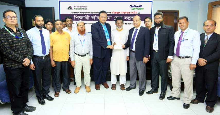 Prof Dr Yousuf M Islam, Vice Chancellor of Daffodil International University handing over a death claim insurance risk coverage cheque for Tk 5 lac to Ali Akbar Talukder father of late Saifull Talukder Mohosin - a BBA student of the University at a formal