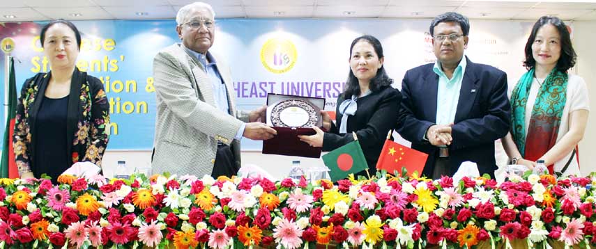 Prof Dr ANM Meshquat Uddin, Vice Chancellor of Southeast University handing over a crest to a Chinese student at an orientation program arranged for newly admitted fifteen Chinese students from Yunnan Minzu University held at SEU campus at Tejgaon in the