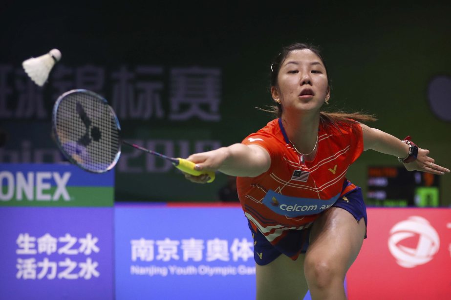 Soniia Cheah of Malaysia plays a shot while competing against Sayaka Sato of Japan during their women's badminton singles match at the BWF World Championships in Nanjing, China on Tuesday.