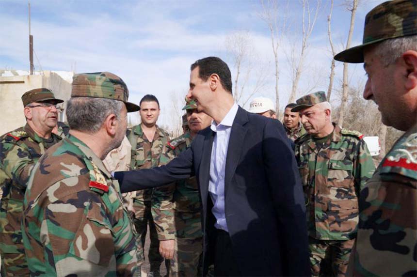 Syrian President Bashar al-Assad greets troops in the Eastern Ghouta district outside Damascus, in his first visit after its recapture from rebels in a Russian-backed offensive.