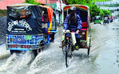 RAJSHAHI: People at Rasjshahi passing hard time due to water- logging caused by heavy rain. This snap was taken from Housing Estate Spura area on Wednesday.