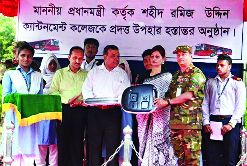 On behalf of Prime Minister Sheikh Hasina, BRTC Chairman Farid Ahmed Bhuiyan handing over keys of five buses to the Principal of the city's Shaheed Ramiz Uddin Cantonment College Nur Nahar Yasmin at the college on Saturday.