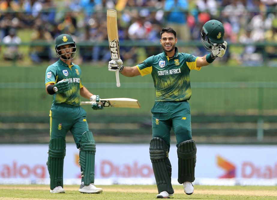 South Africa's Reeza Hendricks (right) raises his bat and helmet to celebrate scoring his maiden century as teammate Jean-Paul Duminy (left) walks to congratulate him during the third one-day international cricket match between Sri Lanka and South Africa