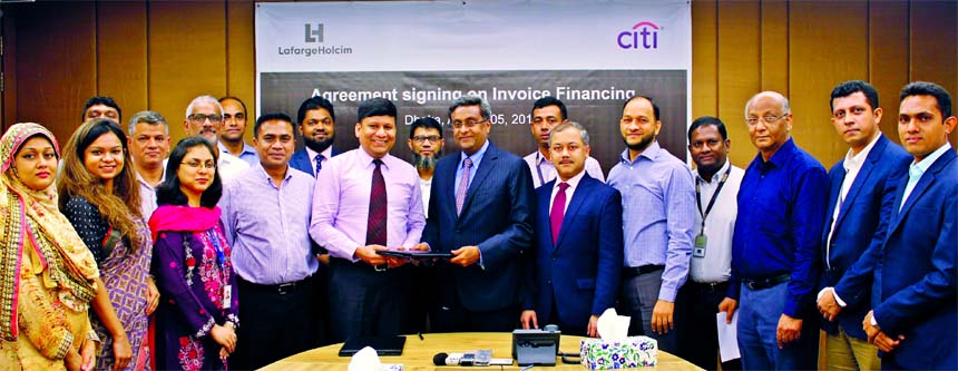 Rajesh K Surana, CEO of Lafarge Holcim Bangladesh Limited and N Rajashe Karan, Managing Director and Country Officer, Bangladesh of Citibank, N A, exchanging an agreement signing document at the Company corporate office in the city on Sunday. Under the de
