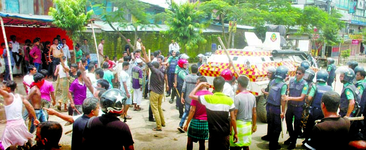 Some unidentified youths wielding sticks along with police rule the city streets. The snap was taken from in front of the East-West University on Monday.