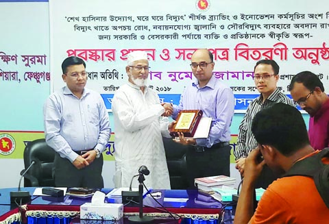 SYLHET: Numari Jaman, DC, Sylhet handing over crest and certificate to Ashfak Ahmed, Chairman, Sadar Upazila for his outstanding contribution in power sectors recently.