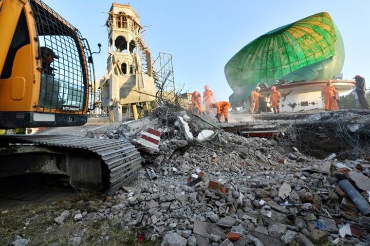 Indonesian rescuers search through the rubble of a mosque in North Lombok that collapsed in Sunday's quake.