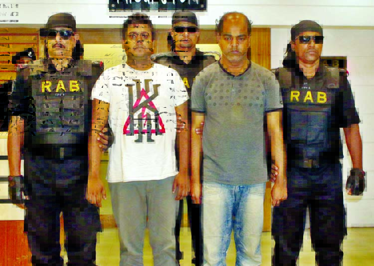 Members of RAB-10 nabbed two persons in cyber crime involved in publishing books with false information from the city's Jatrabari area on Wednesday.