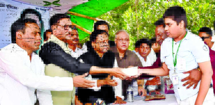 Road Transport and Bridges Minister Obaidul Quader distributing food ad clothes among the orphan and disabled marking the 88th birth anniversary of Bangamata Sheikh Fazilatunnesa Mujib at a ceremony organised by Relief and Social Welfare Sub-Committee of