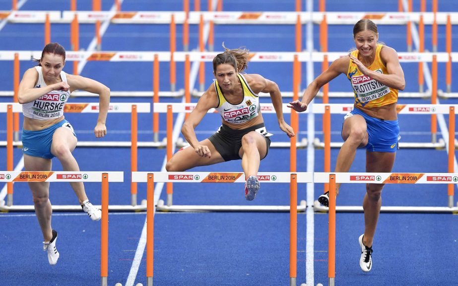 Finland's Reetta Hurske, Germany's Ricarda Lobe and Ukraine's Hanna Plotitsyna (from left) compete in a women's 100-meter hurdles heat at the European Athletics Championships in Berlin, Germany on Wednesday.