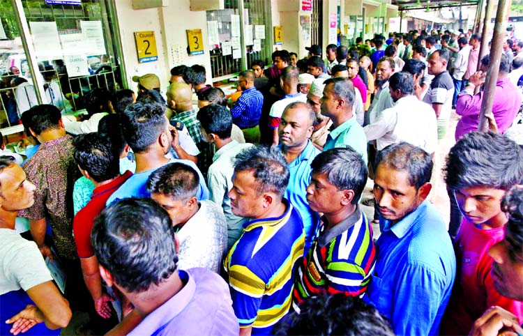 Hundreds of people rush at BRTA office to obtain valid documents of their vehicles and they also seeking renewal of driving licenses. This photo was taken from Mirpur on Wednesday.
