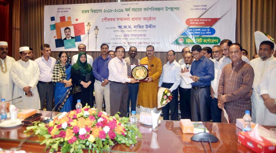 CCC Mayor A J M Nasir Uddin giving honoraray crest to the highest tax payers at the Work Planning and Poura Tax Honourary Programme under CCC Revenue Department as Chief Guest on Wednesday.