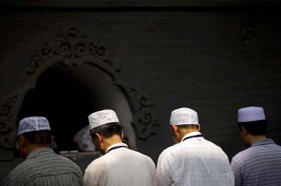 Chinese Hui Muslims pray during Eid al-Fitr prayers at Niujie Mosque in Beijing. Authorities in northwestern China were poised to begin demolition of a mosque on Friday.