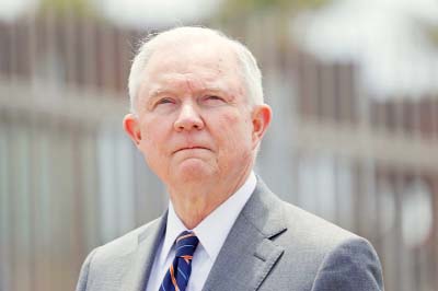 U.S. Attorney General Jeff Sessions looks on during a news conference next to the U.S. Mexico border wall to discuss immigration enforcement actions of the Trump Administration near San Diego, California