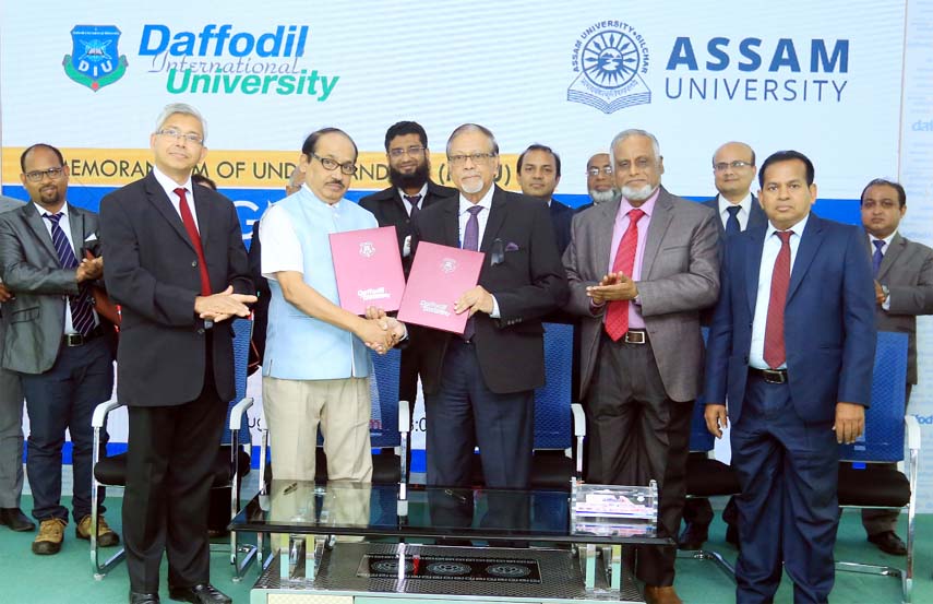 Prof Dr SM Mahabub Ul Haque Majumder, Acting Vice Chancellor of Daffodil International University and Prof Dilip Chandra Nath, Vice Chancellor, Assam University Silchar of Assam, India exchanging documents of a MoU held between the universities on Thursda