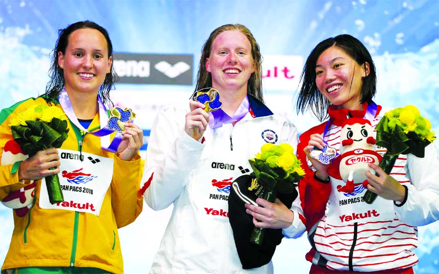 United States Lillia King (centre) stands on the podium after winning the women's 100m breaststroke final with second placed Australia's Jessica Hansen (left) and Japan's third placed Reona Aoki at the Pan Pacific swimming championships in Tokyo, Japan