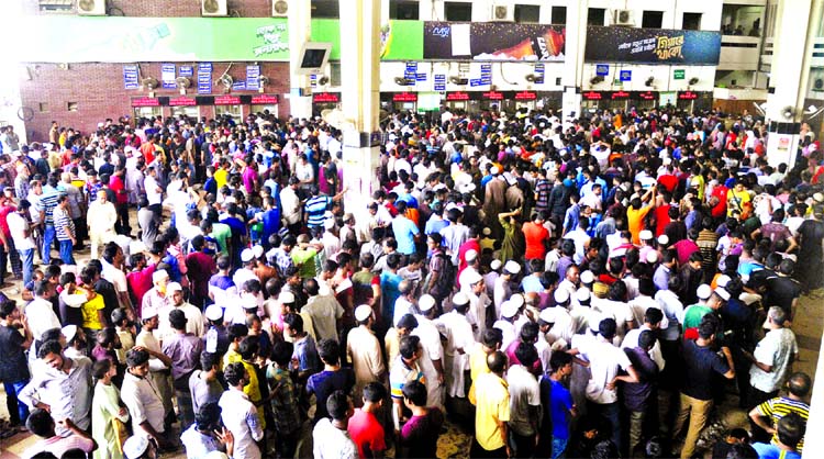 Home-bound people thronged the Kamalapur Railway Station counters for the 3rd day on Friday to buy advance train tickets for celebration of Eid-ul-Azha with their near and dear ones. This photo was taken on Friday.