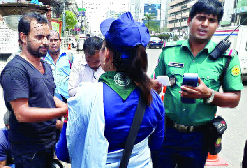 A girl scout detains a traffic violator at city's Shahjahanpur area on Saturday and handed over to police for filing case against him.