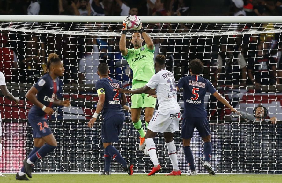 PSG's goalkeeper Gianluigi Buffon (center) controls the ball during their League One soccer match between Paris Saint-Germain and Caen at Parc des Princes stadium in Paris on Sunday.