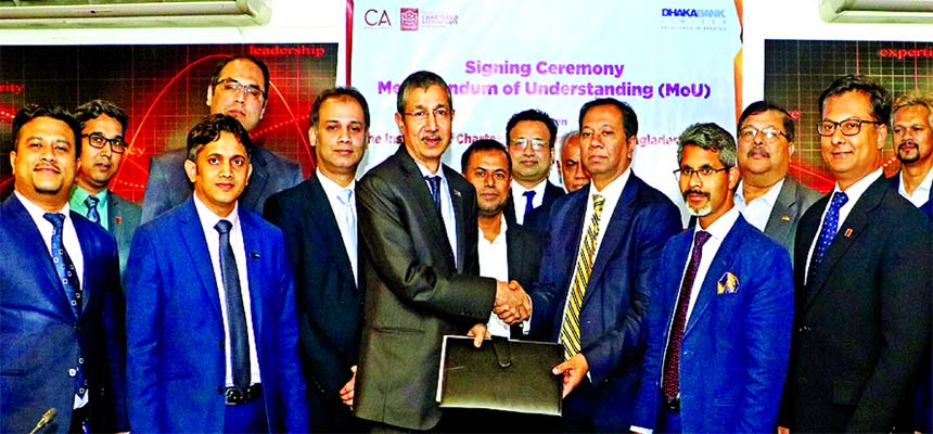 Emranul Huq, Acting Managing Director of Dhaka Bank Limited and Dewan Nurul Islam, President of Institute of Chartered Accountants of Bangladesh (ICAB) exchanging a MoU signing document at ICAB office in the city recently. Under the deal, the Bank will pr
