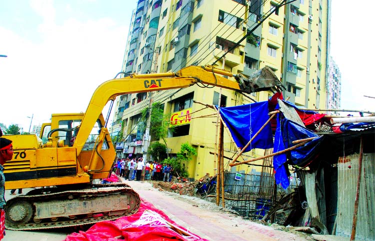 Roads and Highway authorities in a drive evicted illegal establishments at Darussalam Road at Mirpur in city on Tuesday.