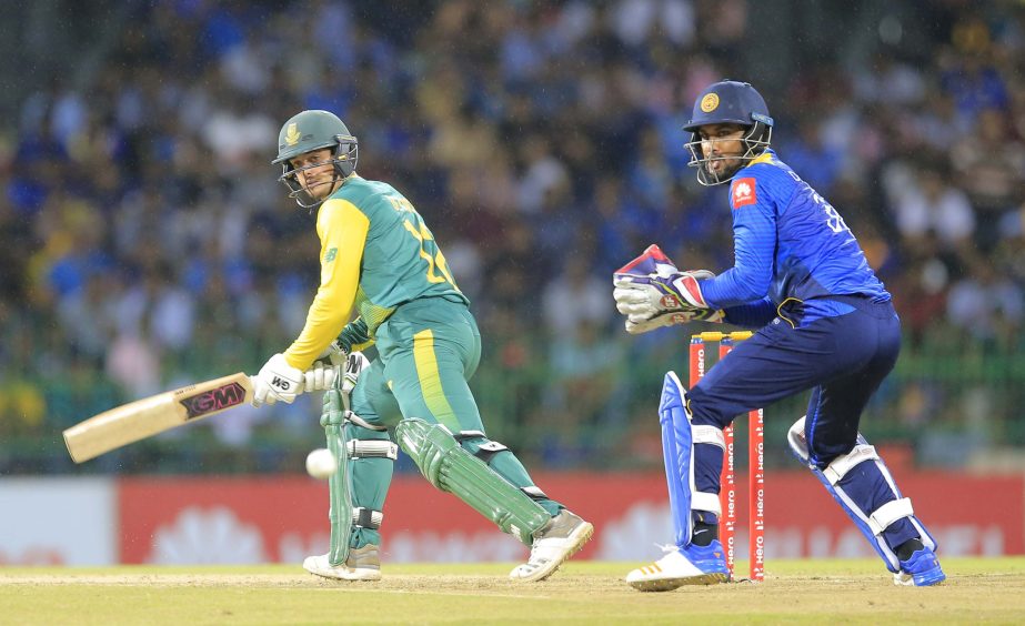South Africa's Quinton de Kock plays a shot as Sri Lanka's Dinesh Chandimal watches during their only Twenty20 cricket match in Colombo, Sri Lanka on Tuesday.