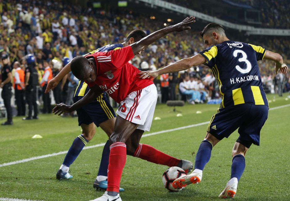 Benfica's Alfa Semedo (left) fights for the ball with Fenerbahce's Baris Alici and Hasan Ali Kaldirim (right) during the Champions League third qualifying round, second leg, soccer match between Fenerbahce and Benfica at the Sukru Saracoglu stadium in I