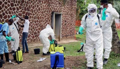 Medical workers at a special treatment centre in Beni disinfect the coffin of a suspected Ebola fatality.