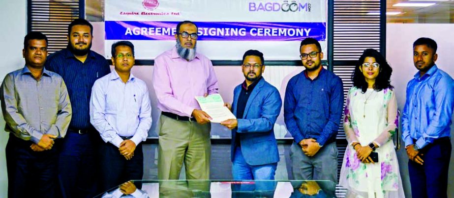 Mirajul Huq, CEO of Bagdoom.com and Manzurul Karim, General Manager of Marketing Division of Esquire Electronics Limited, exchanging an agreement signing document at the electronics' company office in the city recently. Under the deal, all Esquire electr