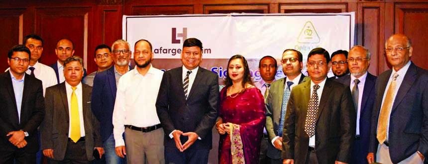 Rajesh K Surana, CEO of LafargeHolcim Bangladesh Limited (LHBL) and Adeeba Rahman, CEO of Delta Life Insurance Company Limited (DLICL), exchanging an agreement signing document at DLICL's head office in the city recently. Under the deal, the insurance co